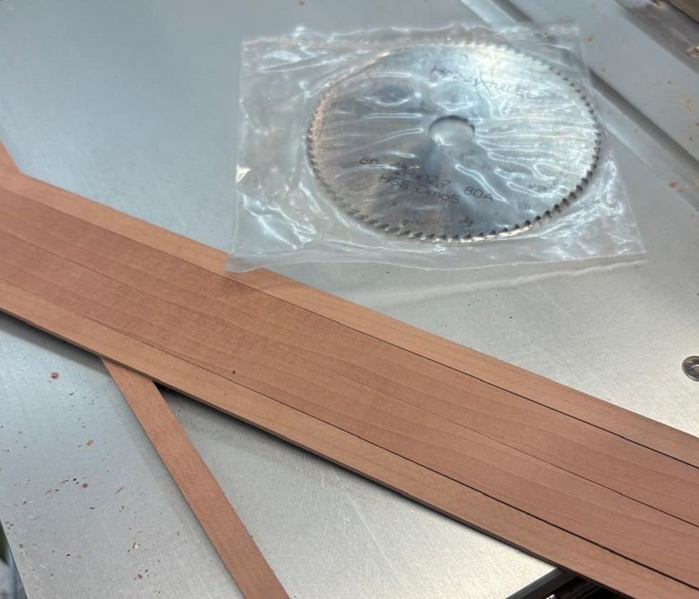 Swiss pear planking strips cut with an 80×1.2 mm hollow ground blade on a Byrnes table saw