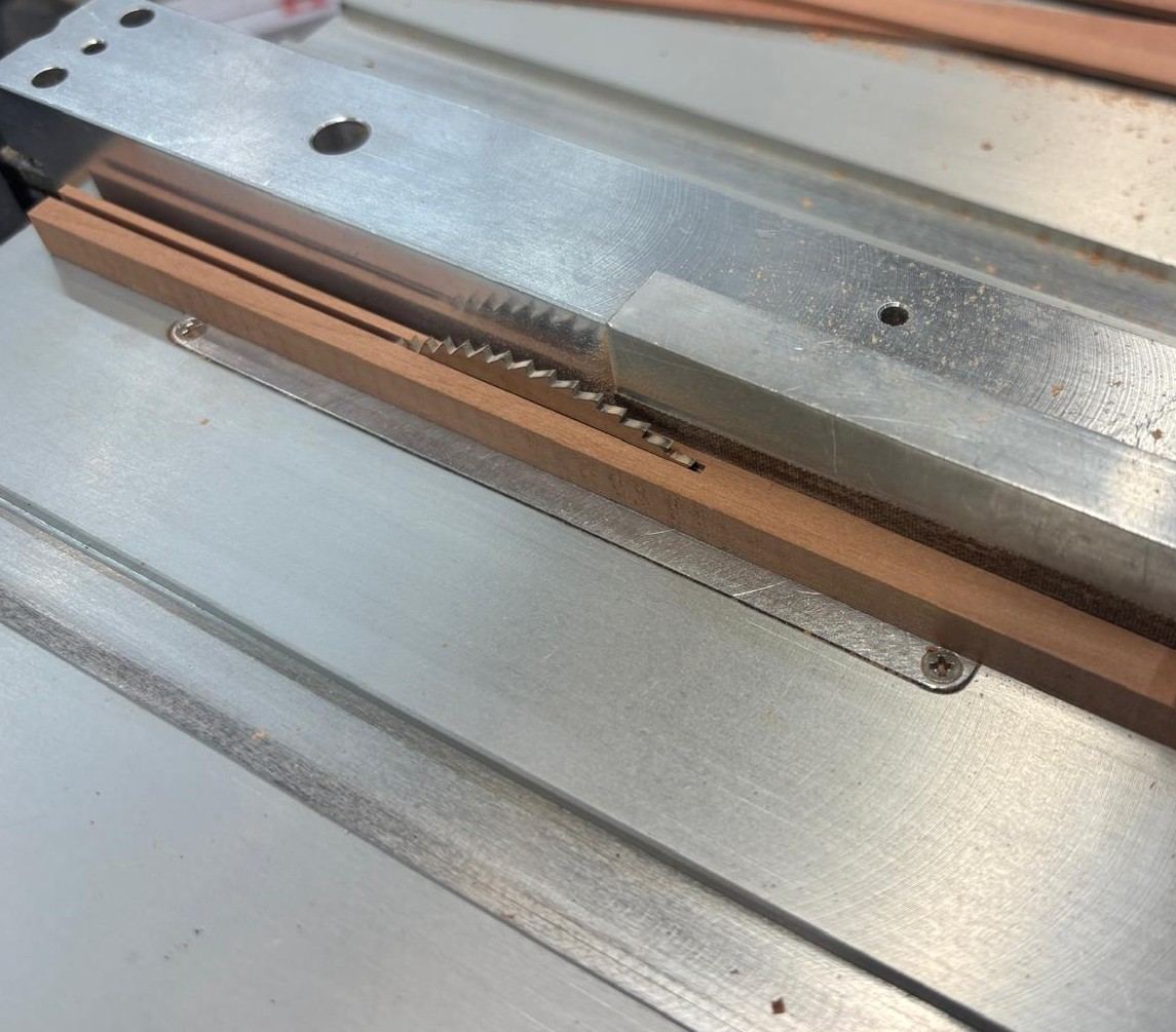 Byrnes table saw fence set with clearance so cut strips do not bind between fence and blade