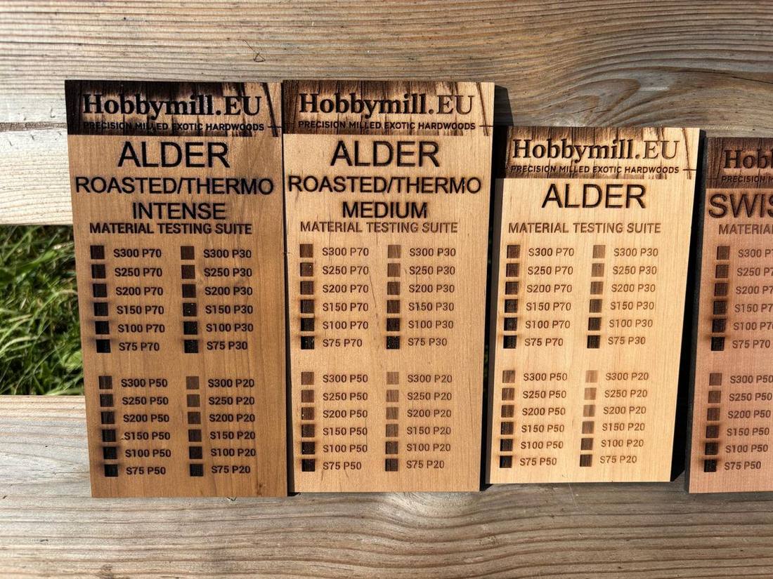 The three alder grades laid side by side next to Swiss pear